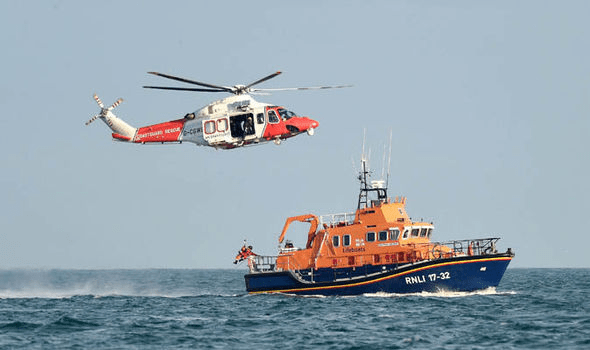 a helicopter flying above a boat