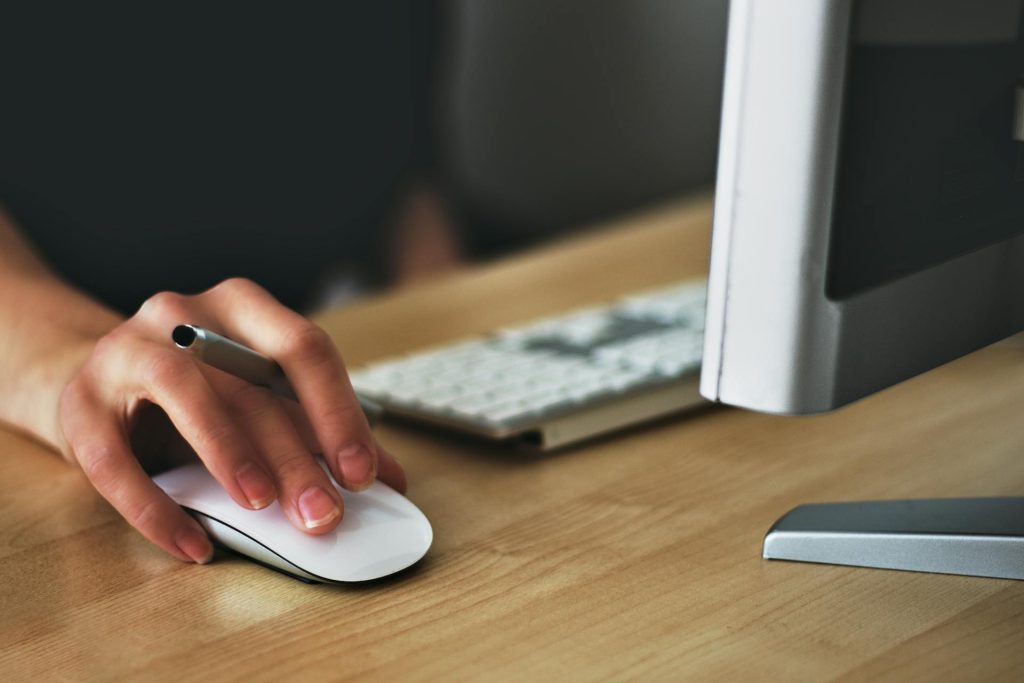 a woman using on of those apple touch mouses