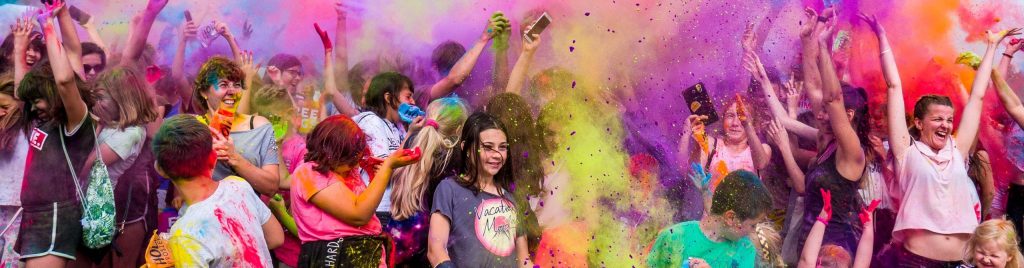 a group of youths at a paint festival