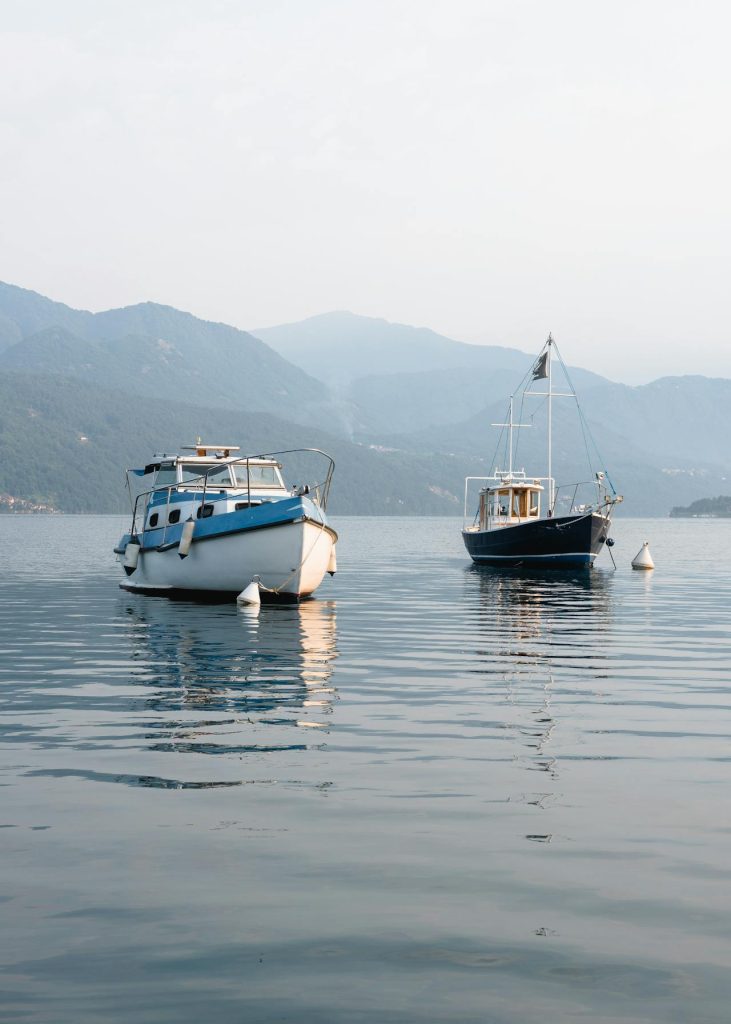 two boats moored in a foggy bay